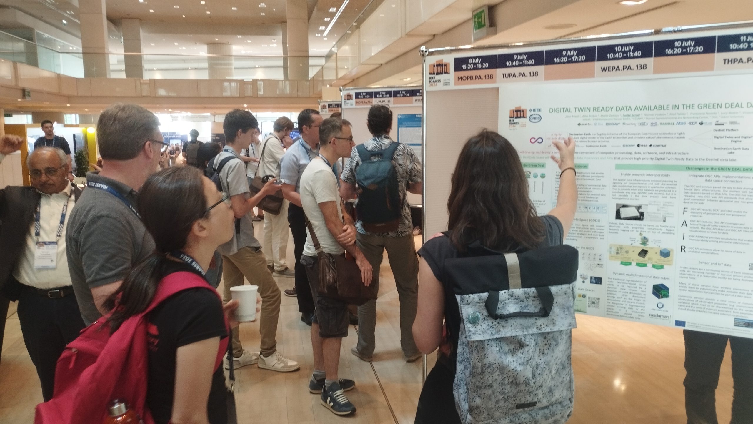 A researcher explaining the content of a scientific poster during the conference.