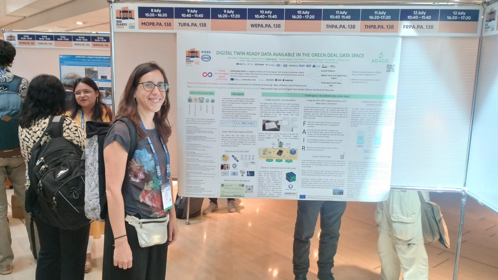 Researcher poses with her poster at the scientific conference.