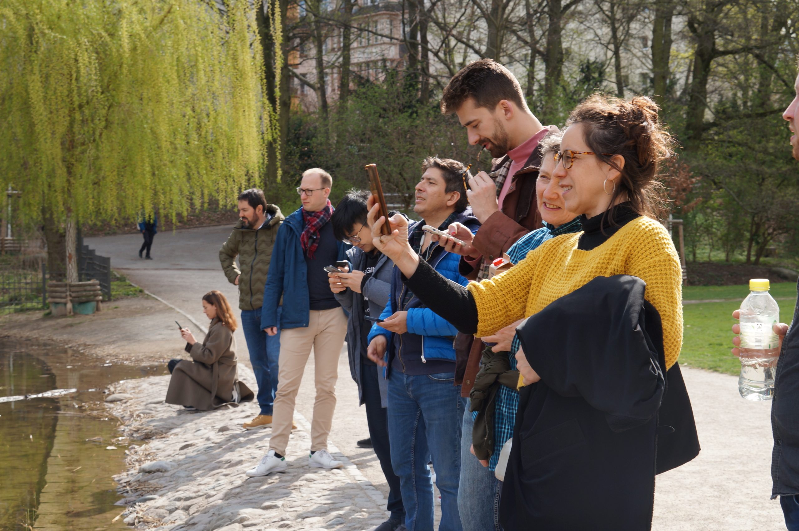 People monitoring the condition of a lake using an mobile phone app.