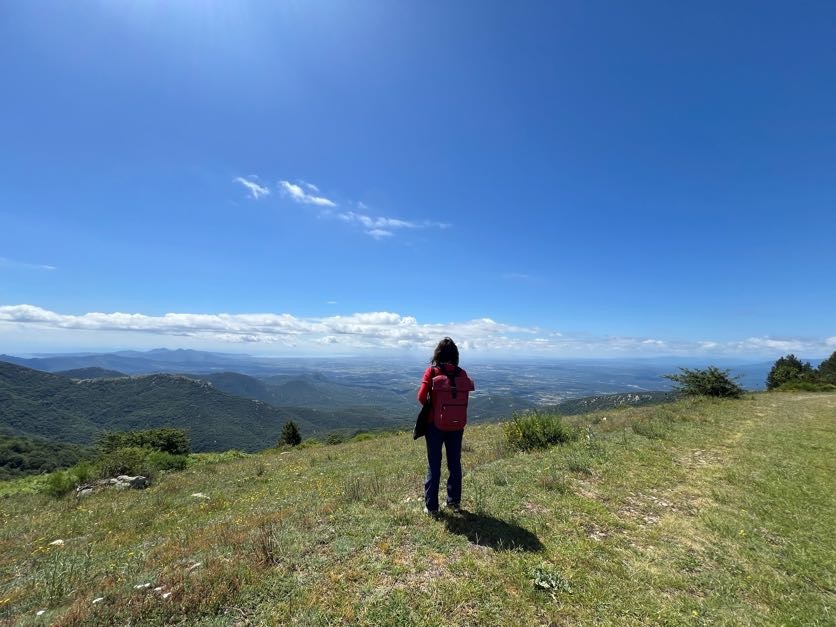 Person looking at the horizon atop a mountain in Catalonia.